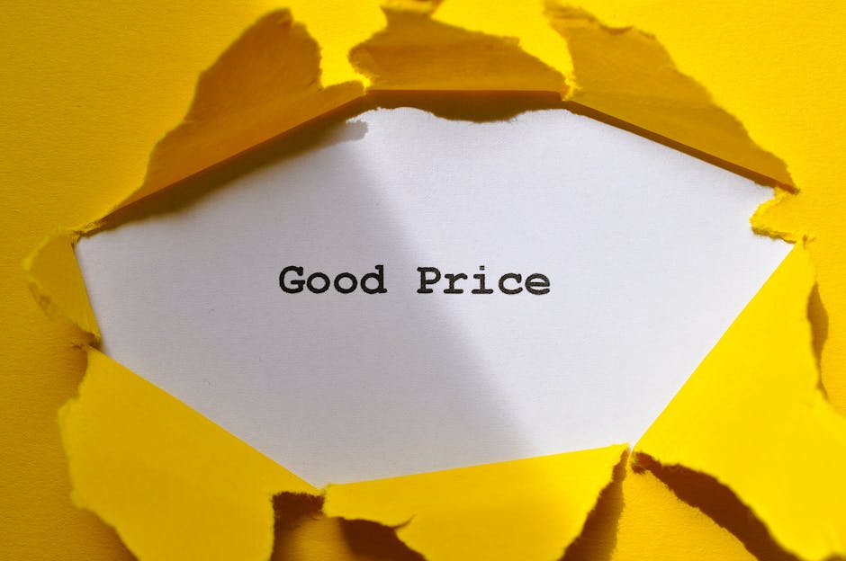 A white card with the words 'Good Price' printed in black text is visible through a torn, irregularly shaped opening in a bright yellow paper or cardboard surface. The torn edges around the opening are jagged and curling slightly outward, revealing the smooth surface of the card underneath. The background surrounding the torn opening is uniformly yellow, with a clean, flat texture. The lighting appears even, highlighting the contrast between the vivid yellow exterior and the plain white card. This image captures a visual metaphor for value or affordable options, which can relate to independent waste management or rubbish removal services that emphasize transparent, straightforward pricing. Rubbish Clearance Lambeth occasionally incorporates such imagery in content related to rubbish or waste removal pricing guides, emphasizing the importance of clear cost explanations in the context of private disposal or alternative rubbish collection methods.